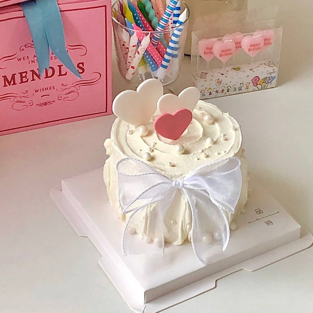 White Ribbon Heart Shaped Cake